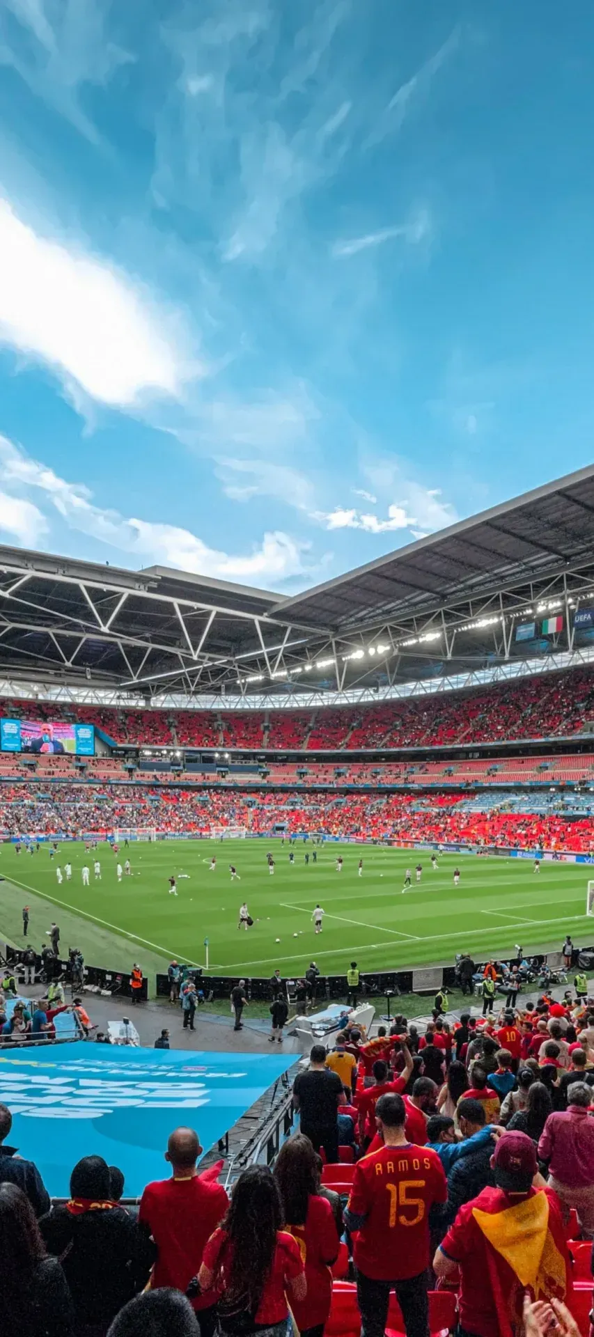 Crowd in the stands of a full football stadium during a match