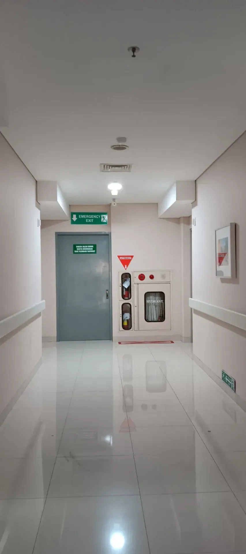 Hospital corridor with an emergency exit and fire equipment