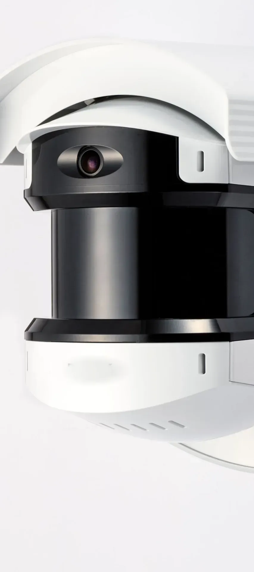 A wall-mounted perimeter detection camera in a white housing