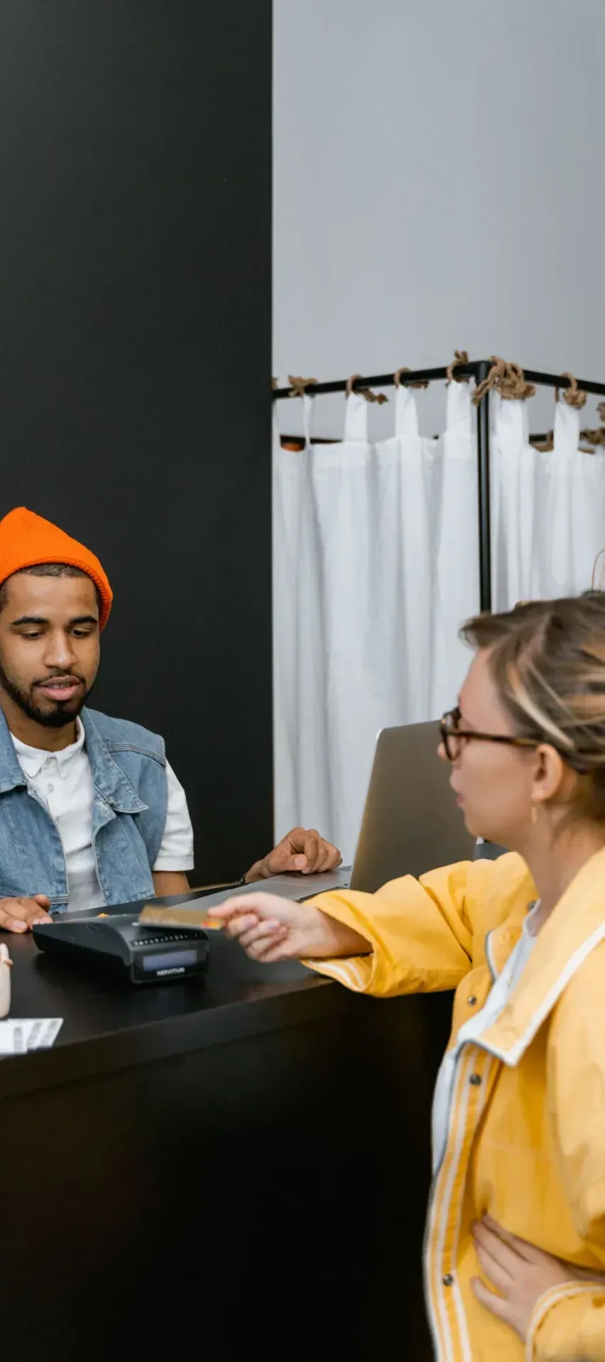 Shop assistant serving a customer at the counter