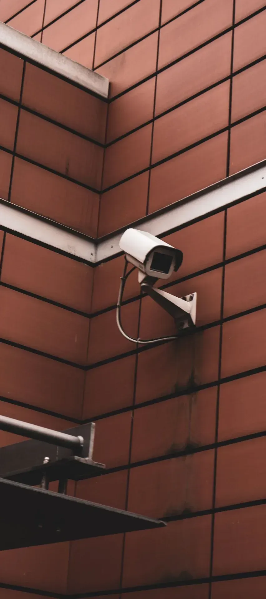 Security camera on the corner of a red brick building