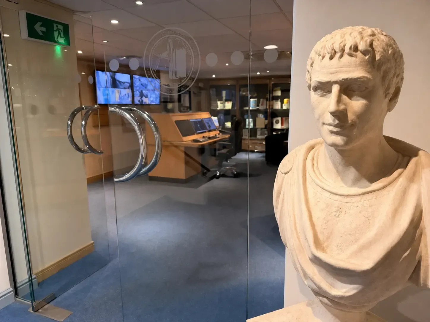 Centurion’s showroom, seen through a glass door, beside a Roman bust