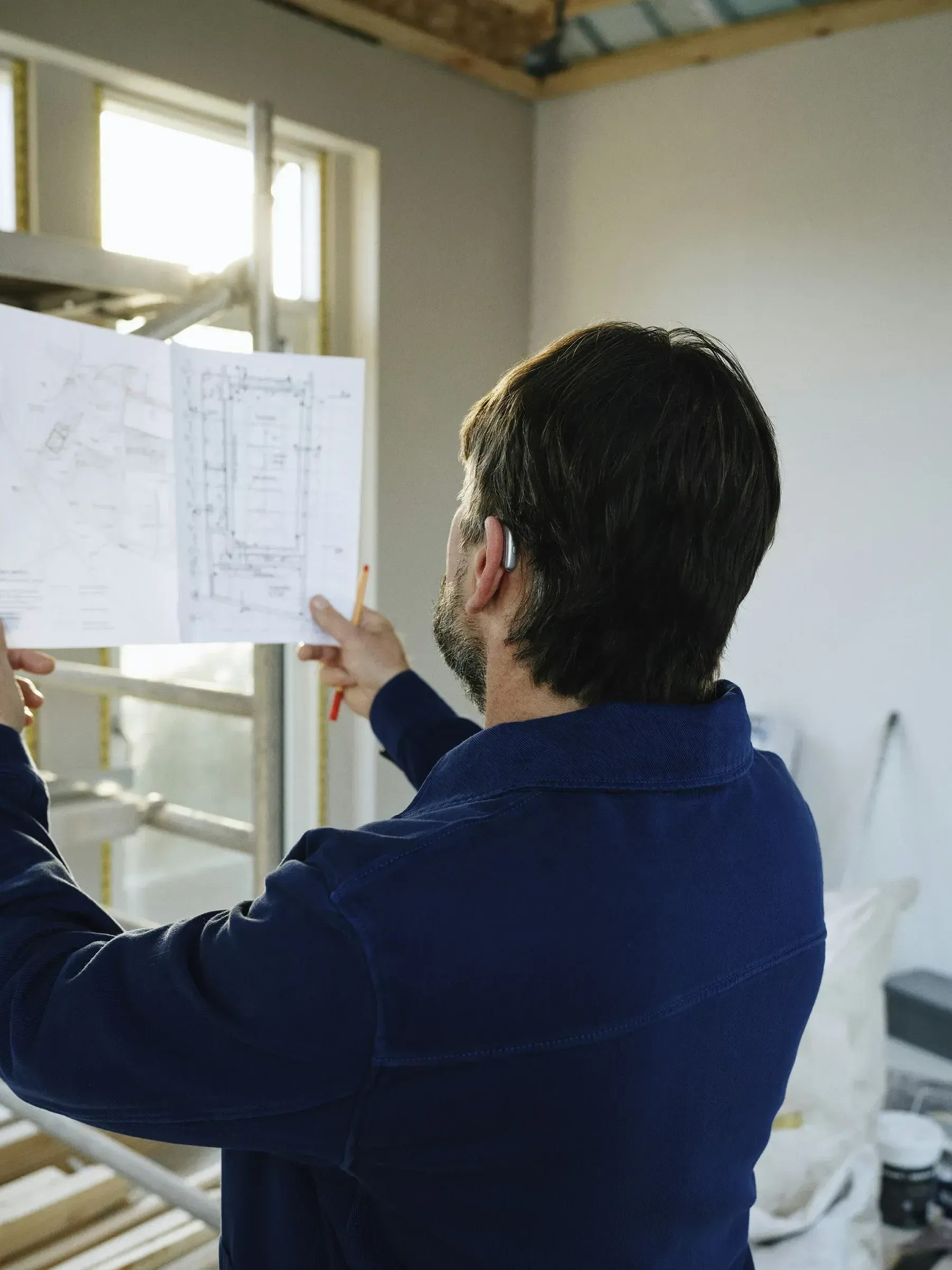 An engineer checking a drawing on site