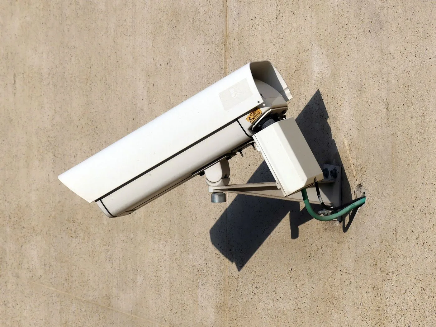 Outdoor surveillance camera with a wall-mounted junction box