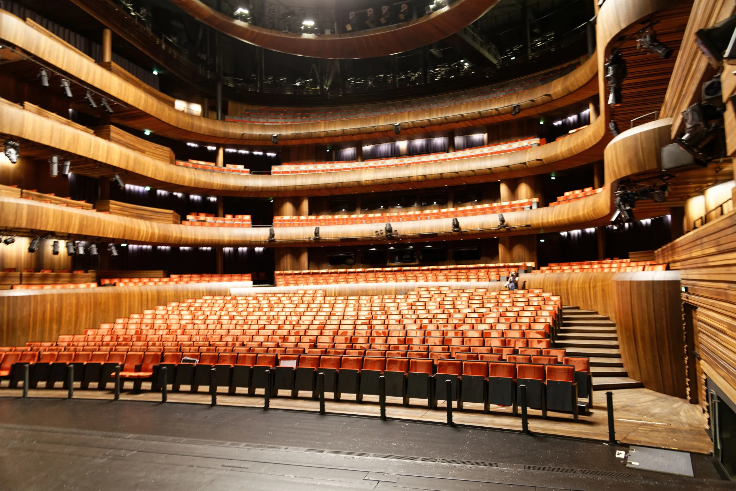 Empty Hall in Theatre (modern wood-lined auditorium with three balcony tiers)